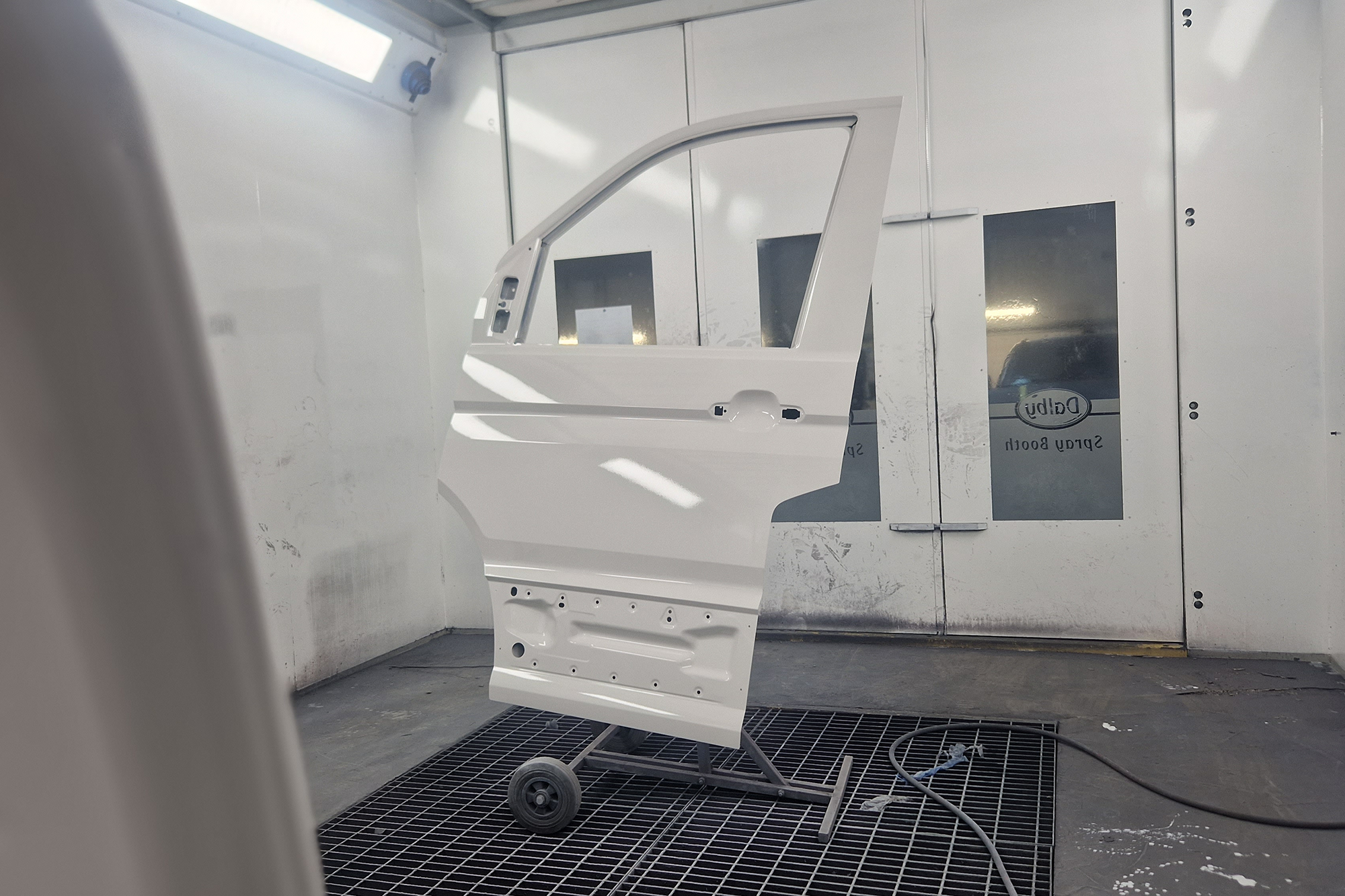 Van doors being painted in a paint oven